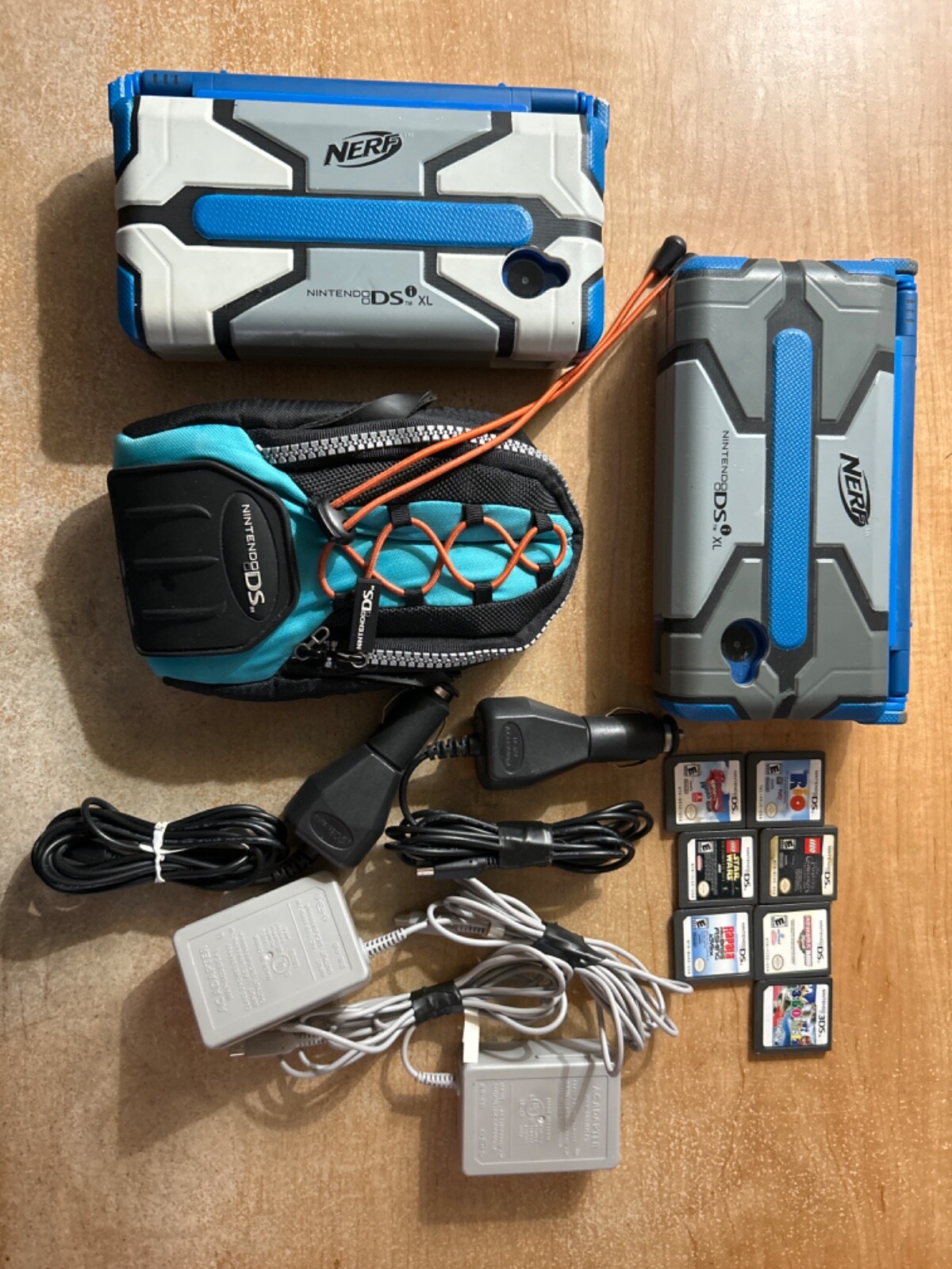 nintendo 2ds xl consoles with nerf cases and games and chargers along
