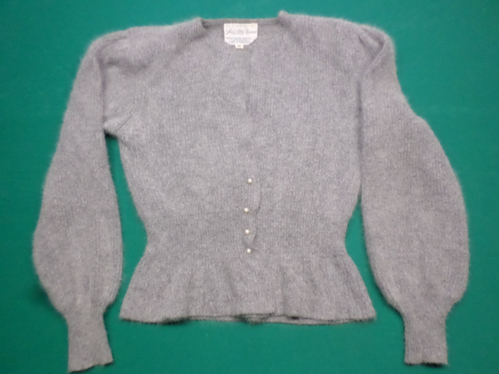 Fitted gray mohair cardigan with pearl buttons and peplum waist