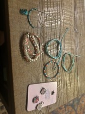 Girls jewelry set. One necklace. Four bracelets and charms.