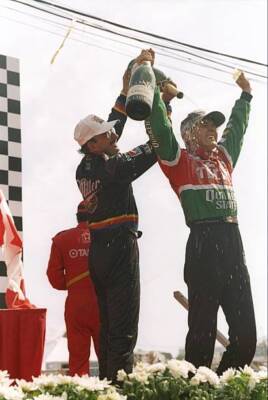 Bobby Rahal left who finished third pours champaigne on a celebrat- Old Photo
