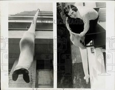 1973 Press Photo A man demonstrates a fire evacuation tube in Paris, France.