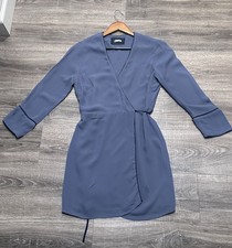 Reformation mini length wrap dress in a grey-blue color, made of 100% viscose.