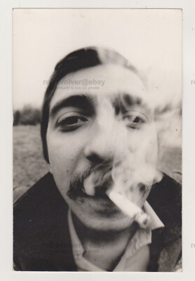 Abstract Young Man's Head Distorted by Cigarette and Smoke in Intense  Close-Up
