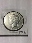 1928 $1 Peace Dollar XF TO AU. Silver. Breaking high grade set. Lovely.