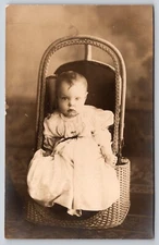 Postcard RPPC Unimpressed Baby Sitting in Wicker Chair Real Photo Children