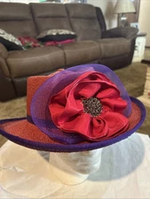 Red Hat Society Women's Red Straw Hat with Purple/ Red Embellished Bow and trim.