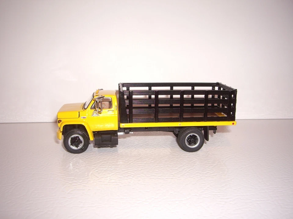 DCP FIRST GEAR 1/64 YELLOW CAB BLACK STAKE SIDE GMC 6500 SINGLE AXLE TRUCK  - Image 2 of 4