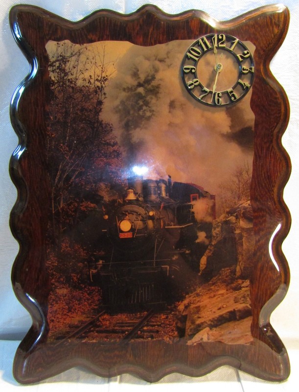 Railroad wood wall clock with a picture of a steam locomotive.