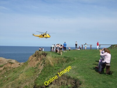 Photo 6x4 R.A.F. Sea King Search and Rescue helicopter over Thornwick Nab c2014