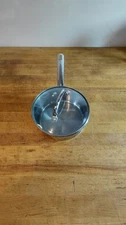 Wolfgang Puck 2 Quart Stainless Steel Saucepan with Glass Lid.