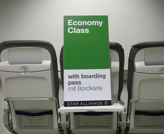 Airport information sign "Economy Class with boarding pass"