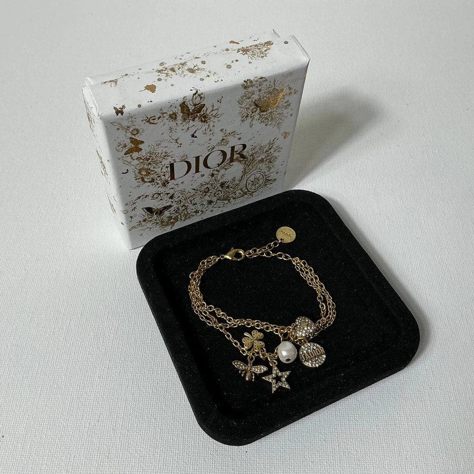 Pulsera con logotipo dorado Dior con caja Foto 2 de 3