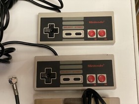 Nintendo NES console bundle with controllers, zapper, and games Tested