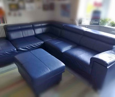 Blue faux leather corner sofa, pull out sofa bed on one side, storage on other