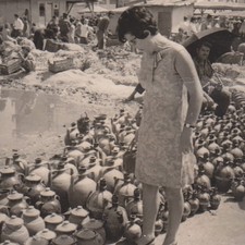 Woman At Pottery Market With Rows Of Clay Jugs Travel Market Scene Vintage Photo