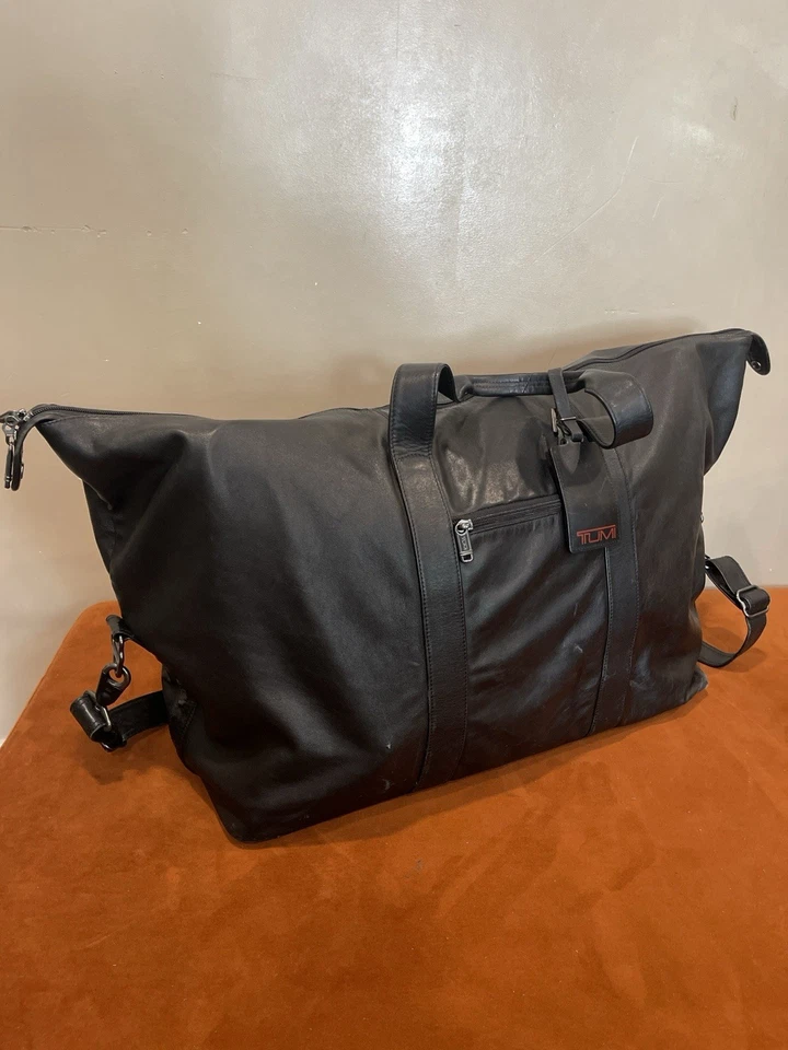 "Lona de fin de semana TUMI XL 22"" CUERO NEGRO con correa para el hombro y etiqueta para equipaje" Foto 2 de 4