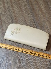 Vintage Baronet Fifth Avenue clutch wallet features a cream leather exterior