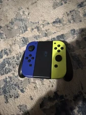 Nintendo Switch Neon, Yellow And Neon Blue Controllers, And Controller Grip