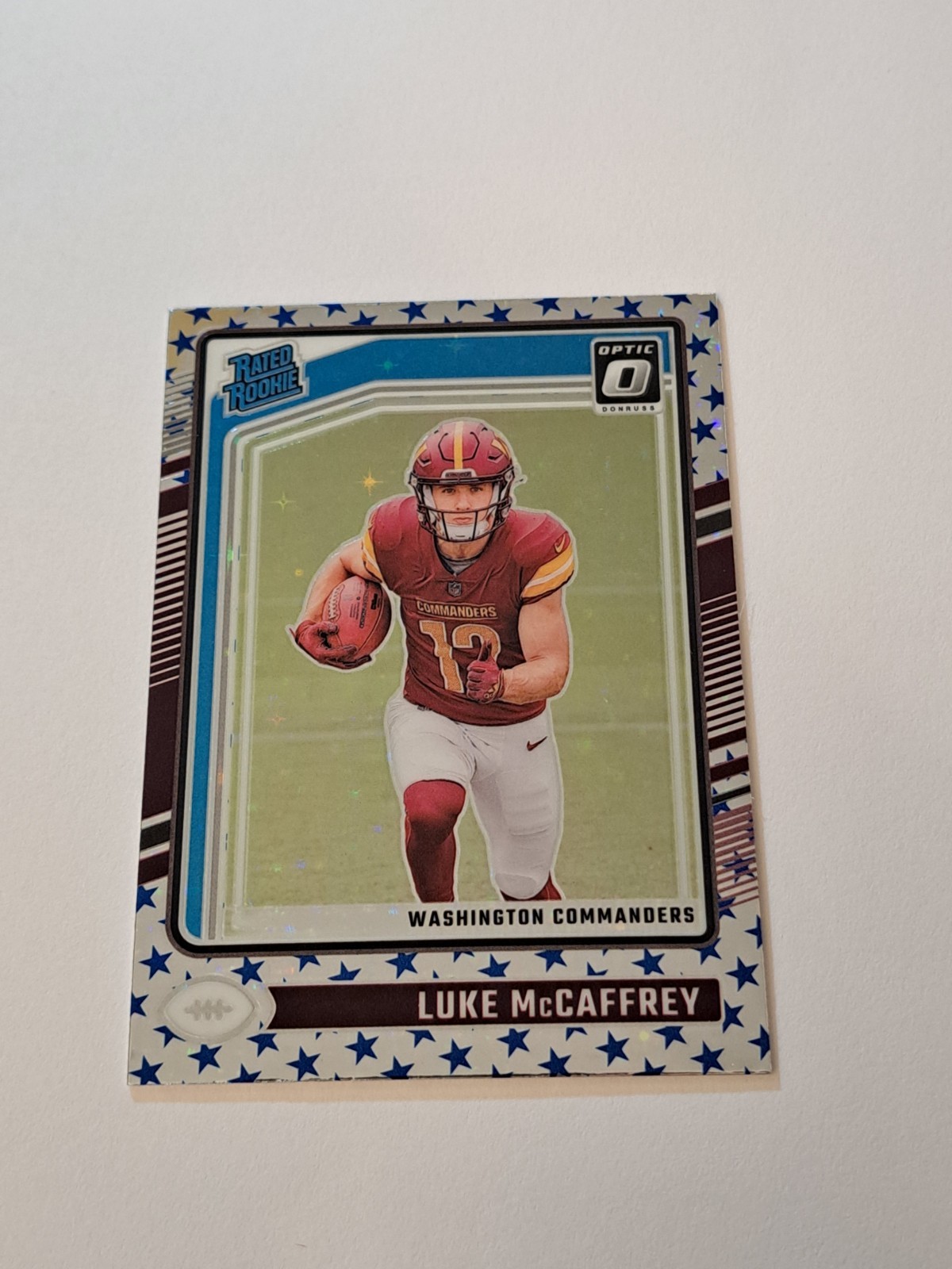 Luke McCaffrey Rookie 2024 Donruss Optic Stars Emoji Prizm RC #268 In Toploader