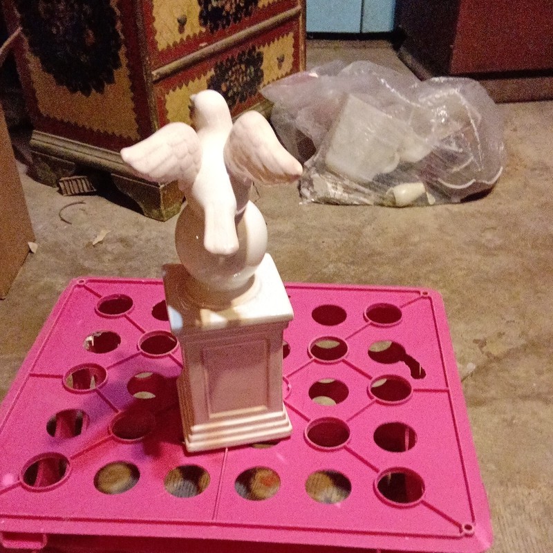 Pier 1 pigeon dove ceramic figurine perched on a stone pillar.