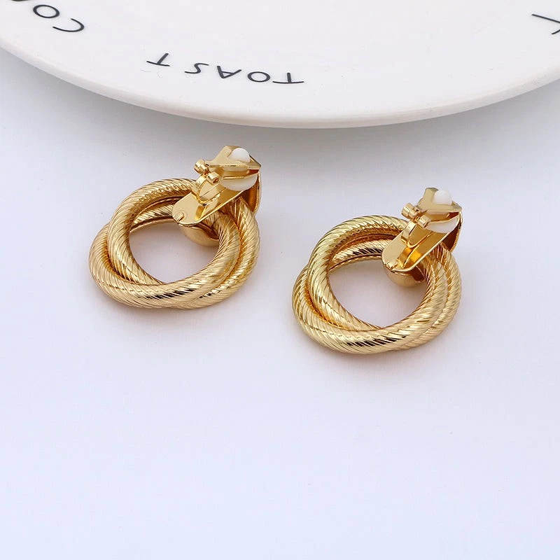 Clip on 1 1/2" gold textured loose knot button style earrings - Image 2 of 2