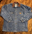 Blue denim Carhartt C59 chore coat with brown collar, front buttons, and small yellow Carhartt logo patch on chest.