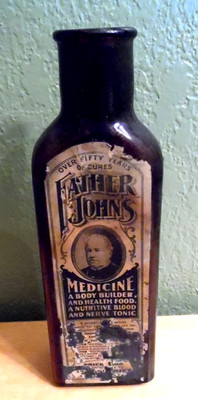 ANTIQUE FATHER JOHNS AMBER MEDICINE BOTTLE WITH ORIGINAL LABEL 9 1/2'' HIGH