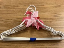 lot of 8 childrens clothes hangers Pink And Red Bows