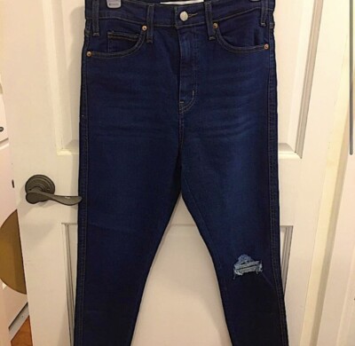 Dark blue jeans, with holes.