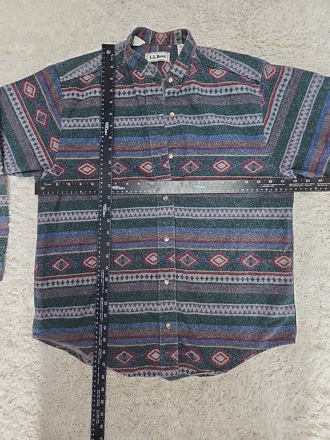 Vintage LL Bean men’s L shirt with blue, red, and beige Aztec flannels, button-down front, and chest pocket.