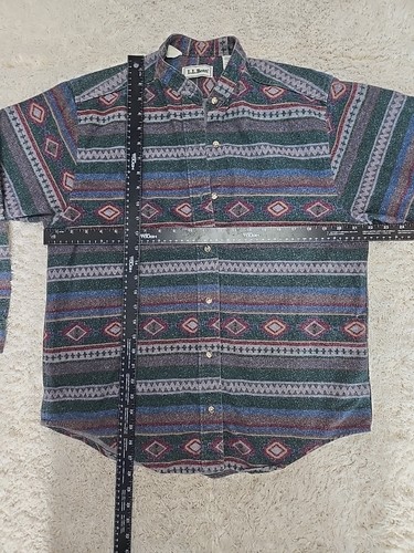 Vintage LL Bean men’s L shirt with blue, red, and beige Aztec flannels, button-down front, and chest pocket.