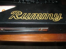 NEW RUMMY GAME.NEVER USED AND IN LEATHER CASE. COMES WITH 4 STANDS,TILES, ETC.