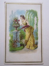 vintage embossed Victorian trade card women in beautiful dress flowers