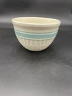 Vintage Hull Pottery ribbed mixing bowl with aqua blue stripes.