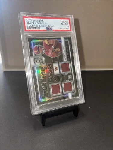 2024 Spectra Jayden Daniels Building Blocks Relic /99 PSA NM MT 8 (Cracked Case)