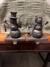 Pair Of Rustic Snowman Resin Stocking Hanger Holder & Cast Iron Mantle Base