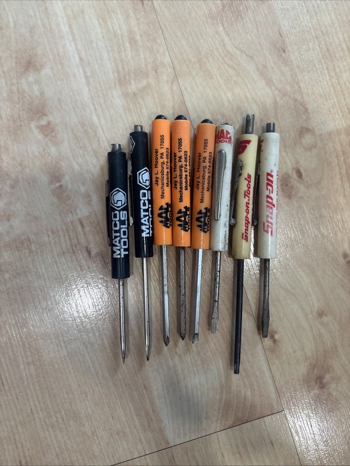 A lot of vintage mini advertising screwdrivers from Snap-On, Matco, and MAC Tools — tiny branded pocket tools that are legitimate collector items in the mechanic/trades world.