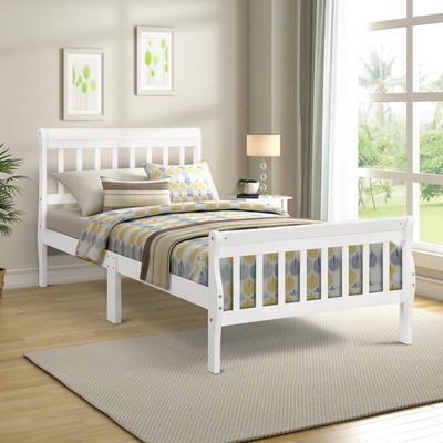 Wooden platform bed with headboard and footrest supported by wooden strips