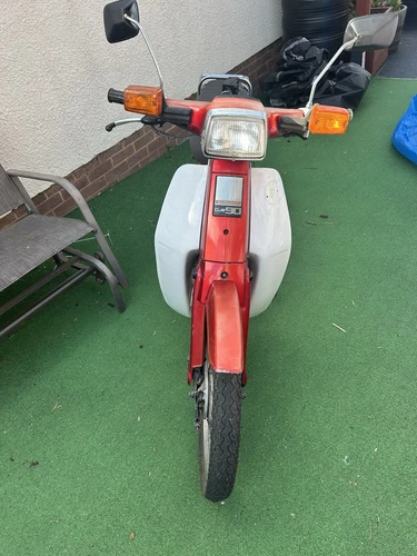 Honda C90 Motorcycle. Red Original 1994 Lovely Little Girl.