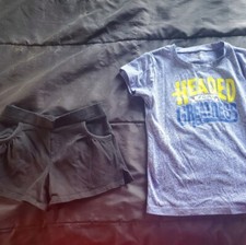 girl 5 Under Armour tee and black shorts