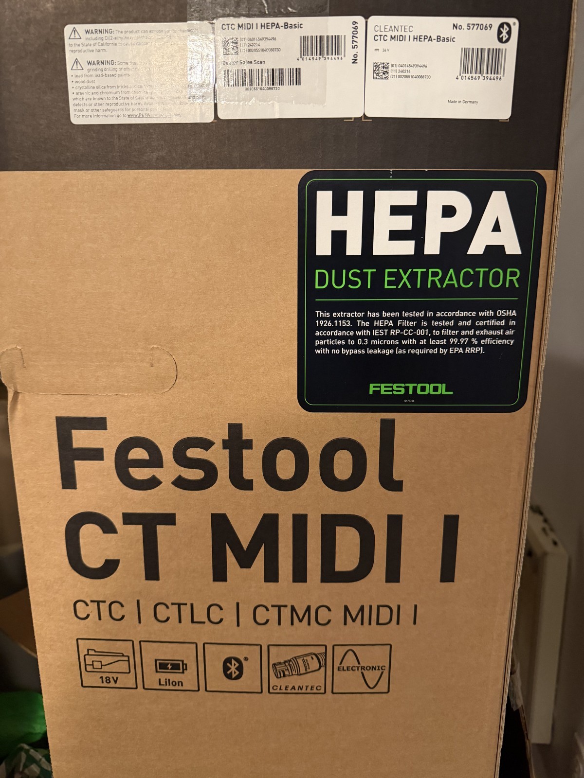 Black and white Festool box showing image of CLEANTEC CTC MIDI I HEPA vacuum with yellow logo and red HEPA filter indicator.