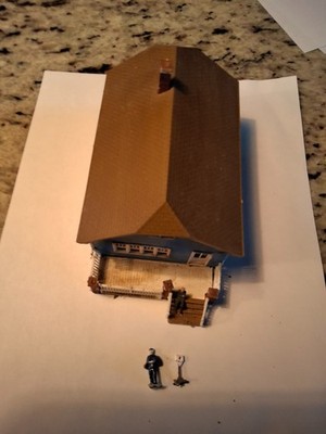 corner stone by walthers one story houe with mailman and mailbox , man on porch