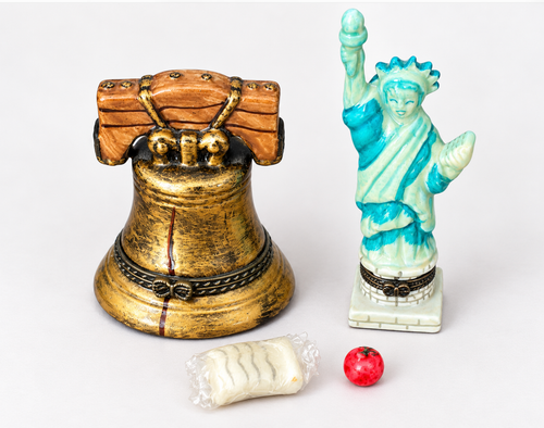 Gold Liberty Bell trinket box with blue Statue of Liberty figure and matching red, white, and blue box with gold accents.