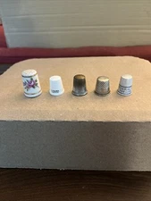 VINTAGE SET OF 5 THIMBLES 3 METAL/1 PLASTIC/ 1 PORCELAIN CHIPPED