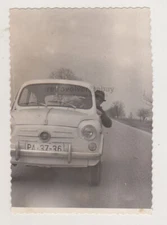 Handsome Young Man Behind the Wheel of Fiat 750 Playfully Peeking through Window
