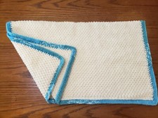 Handknitted, acrylic 24x26in, off white w/turquoise trim baby stroller blanket