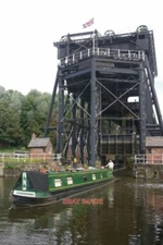 PHOTO  ANDERTON BOAT LIFT 'FESTINA LENTE' LEAVES THE LIFT AND JOINS THE RIVER WE