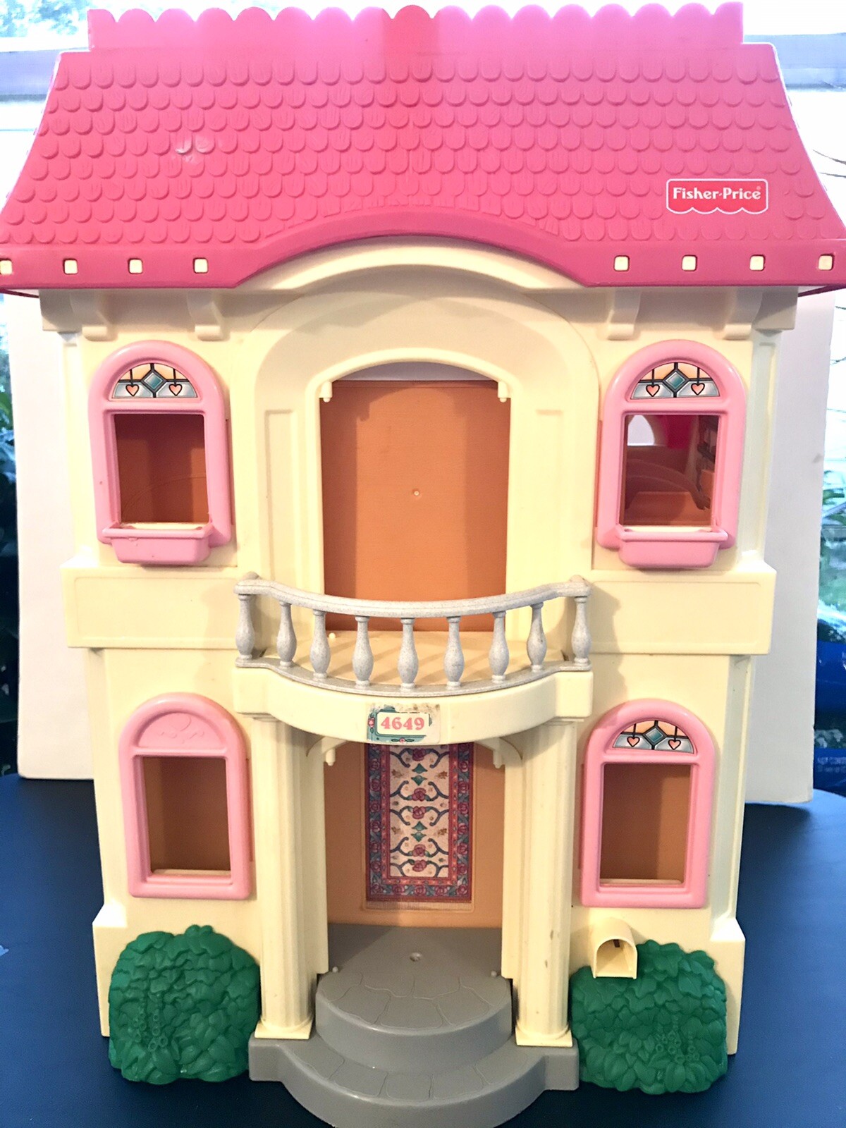 yellow dollhouse with pink roof