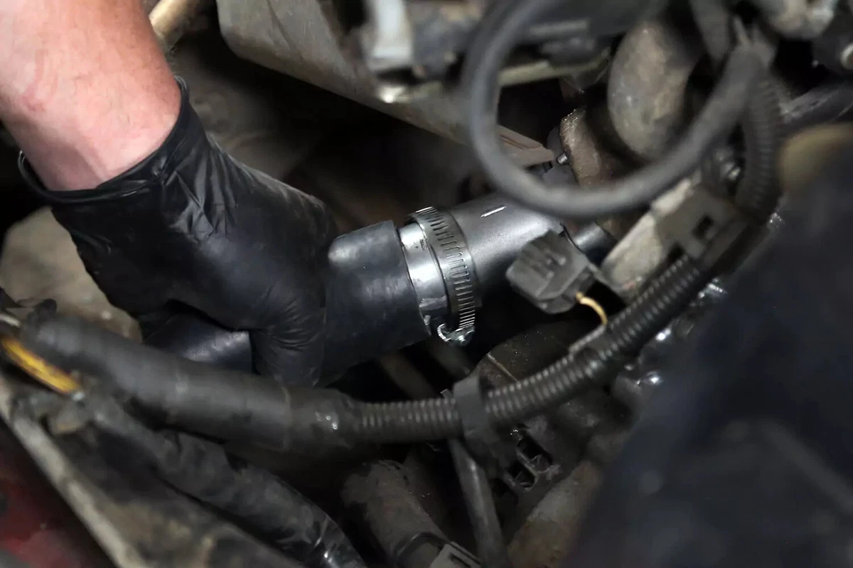 Reconnecting the radiator hose.