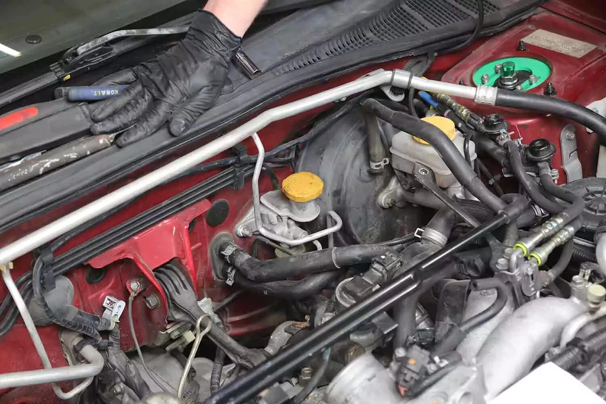The clutch master cylinder with a yellow cap.